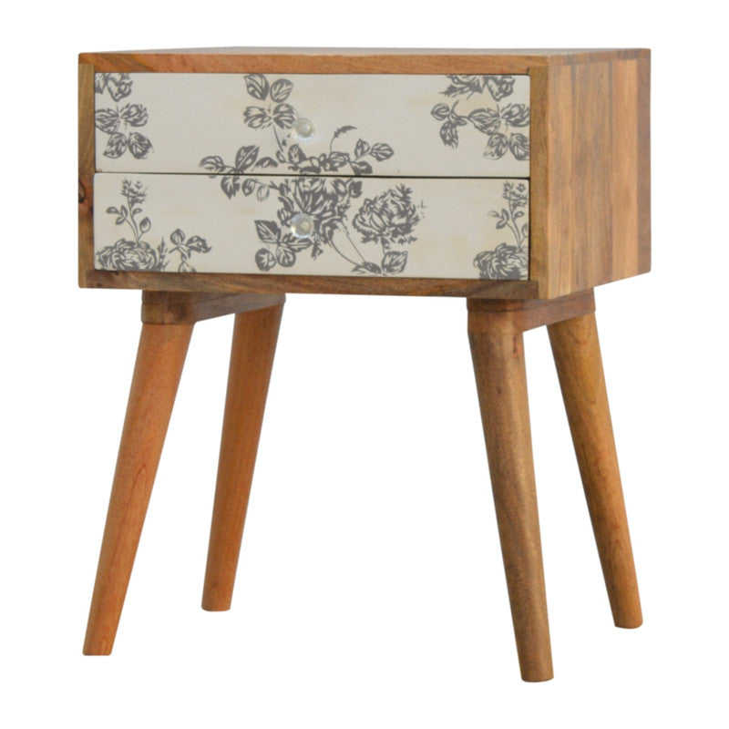 Black floral screen-printed bedside furniture by Jade Epimetheus with intricate floral design and modern style.