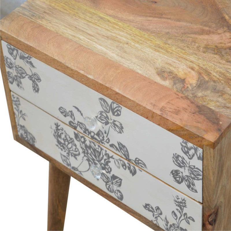 Black floral screen printed bedside table from Jade Epimetheus, featuring intricate floral design and modern furniture style.