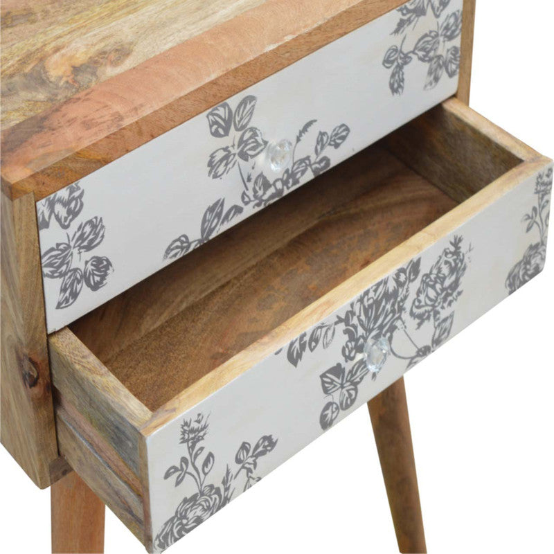 Black floral screen printed bedside table by Jade Epimetheus, featuring decorative floral design and modern furniture style.