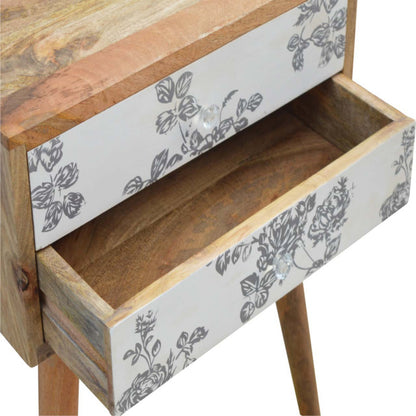 Black floral screen printed bedside table by Jade Epimetheus, featuring decorative floral design and modern furniture style.