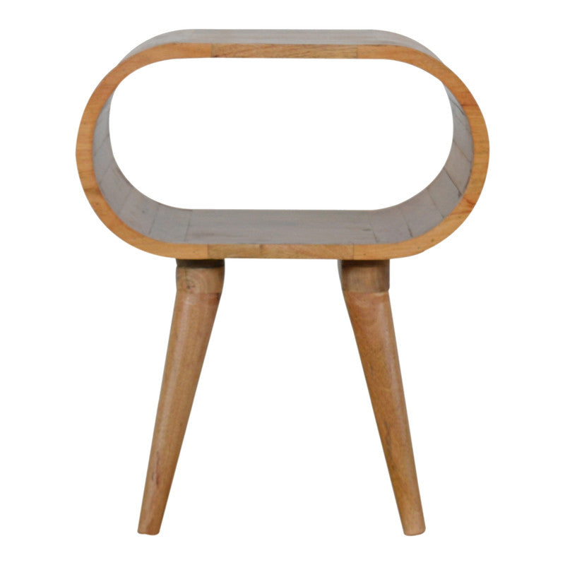 Circular open bedside table from Jade Epimetheus, featuring a sleek wood finish and open shelving for modern bedroom storage.