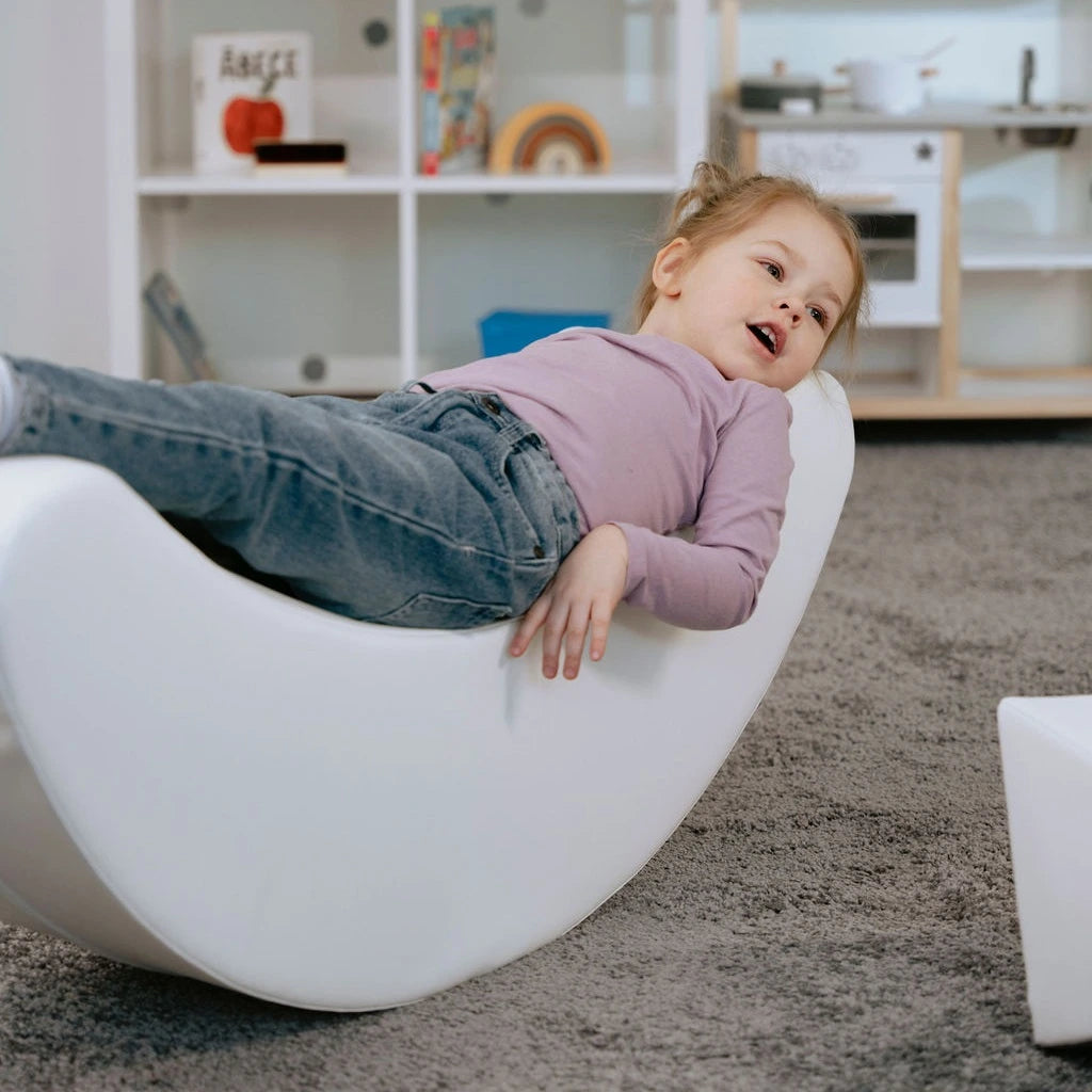Blush Apricot Iglu furniture piece with a sleek, modern design featuring a banana-shaped form in neutral sand color.