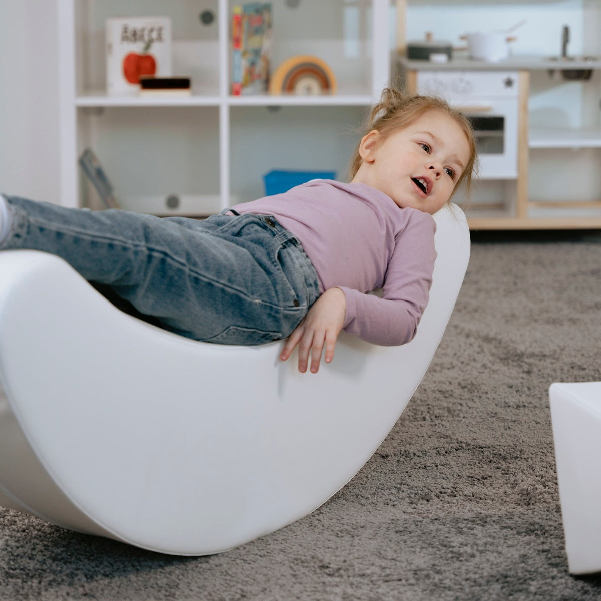 Blush Apricot Iglu banana-shaped furniture piece in sand-colored fabric with a cozy, modern design.
