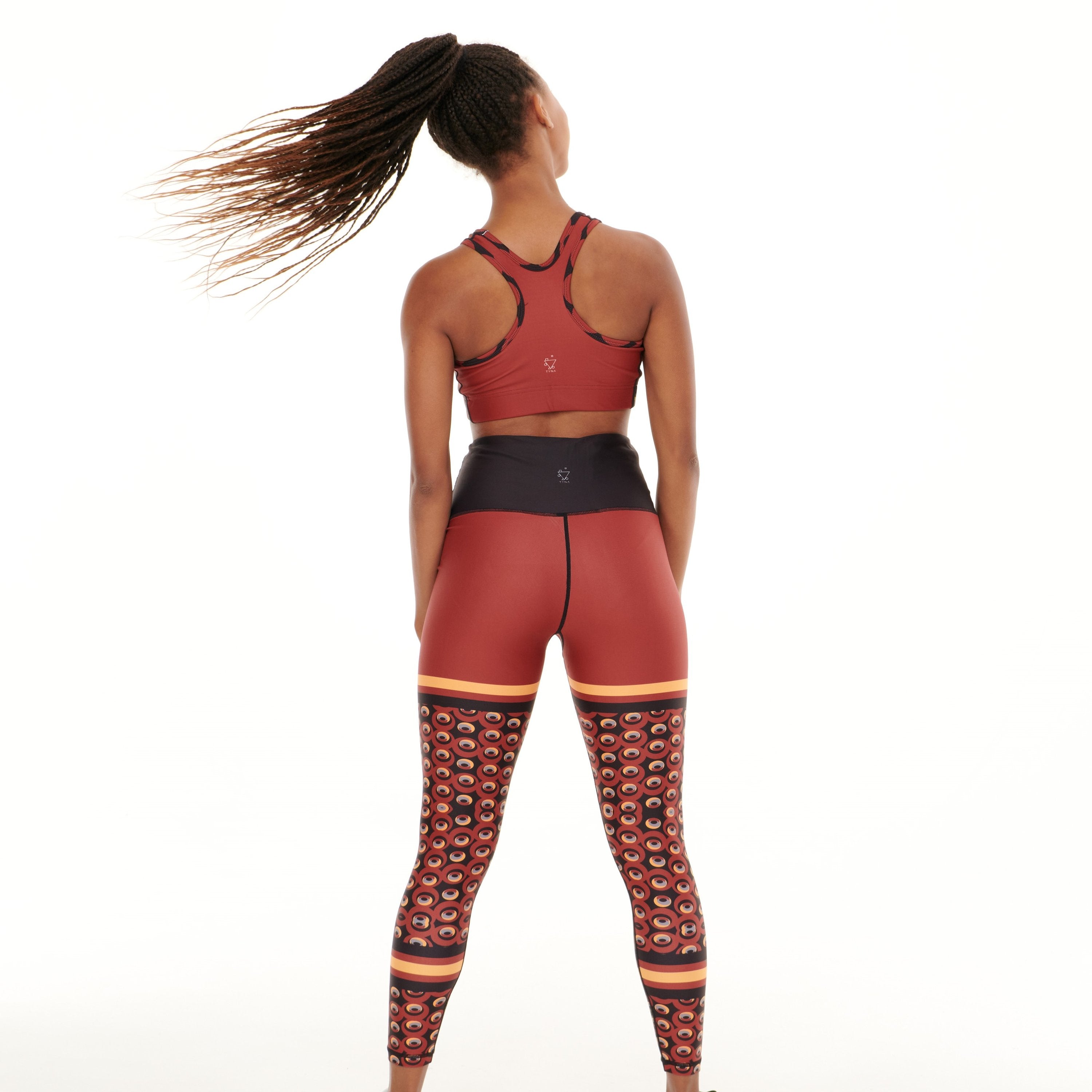 White Oliver Siefay on iron red funky activewear leggings with bold patterns and a snug fit, perfect for workout or casual wear.