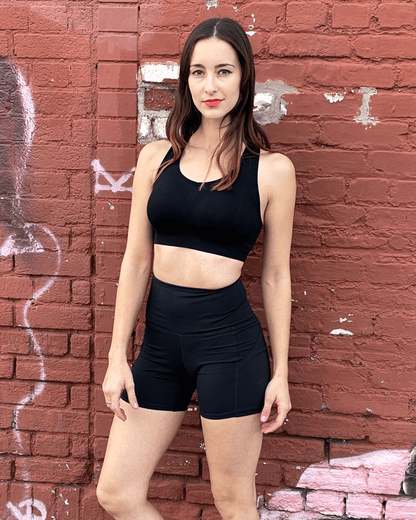 Black Lavender Jolie high-waisted athletic shorts with hip pockets, shown in black with a fitted waistband and functional side pockets.