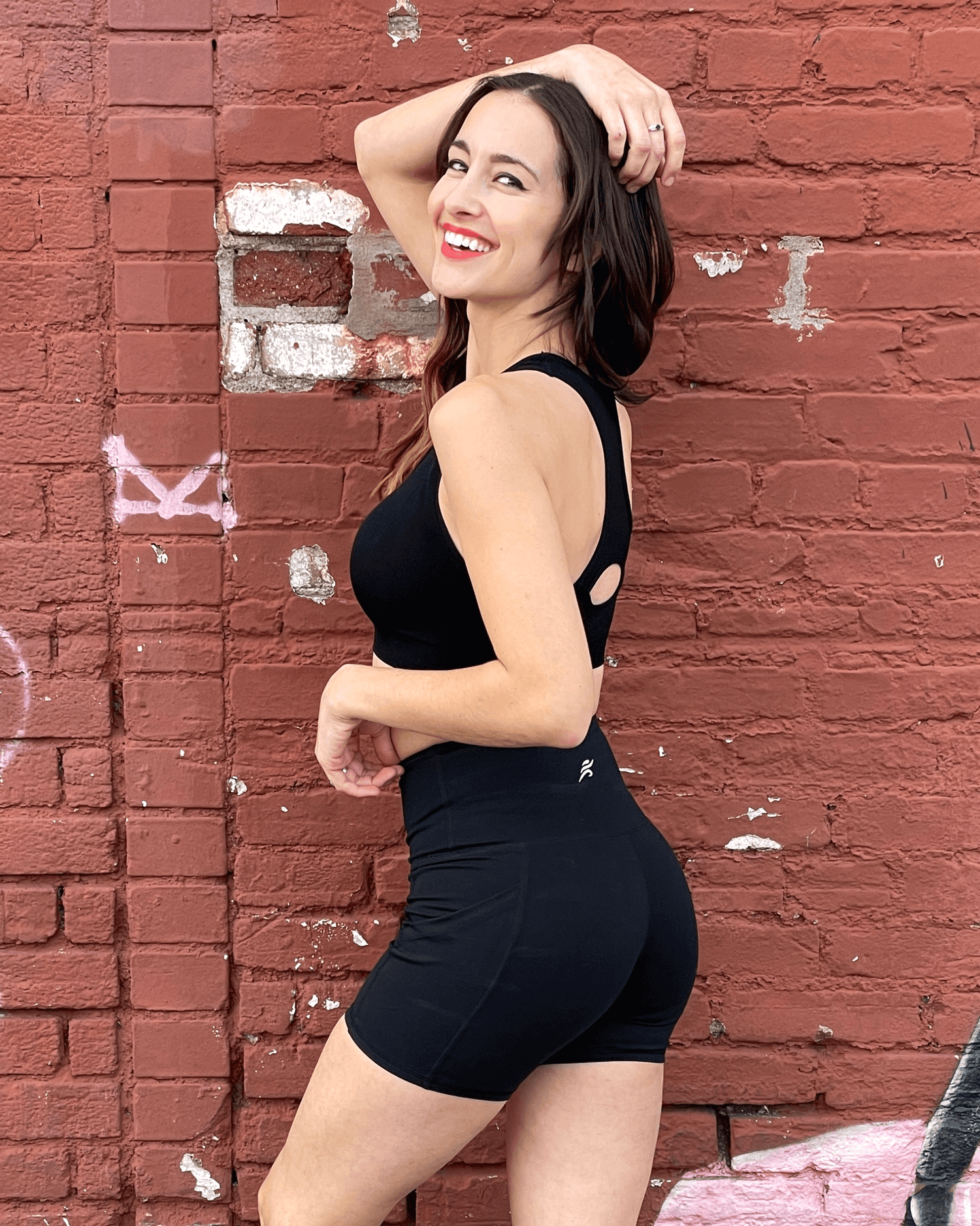 Black Lavender Jolie high-waisted athletic shorts with hip pockets, made for activewear, shown in dark color with stretch fabric.
