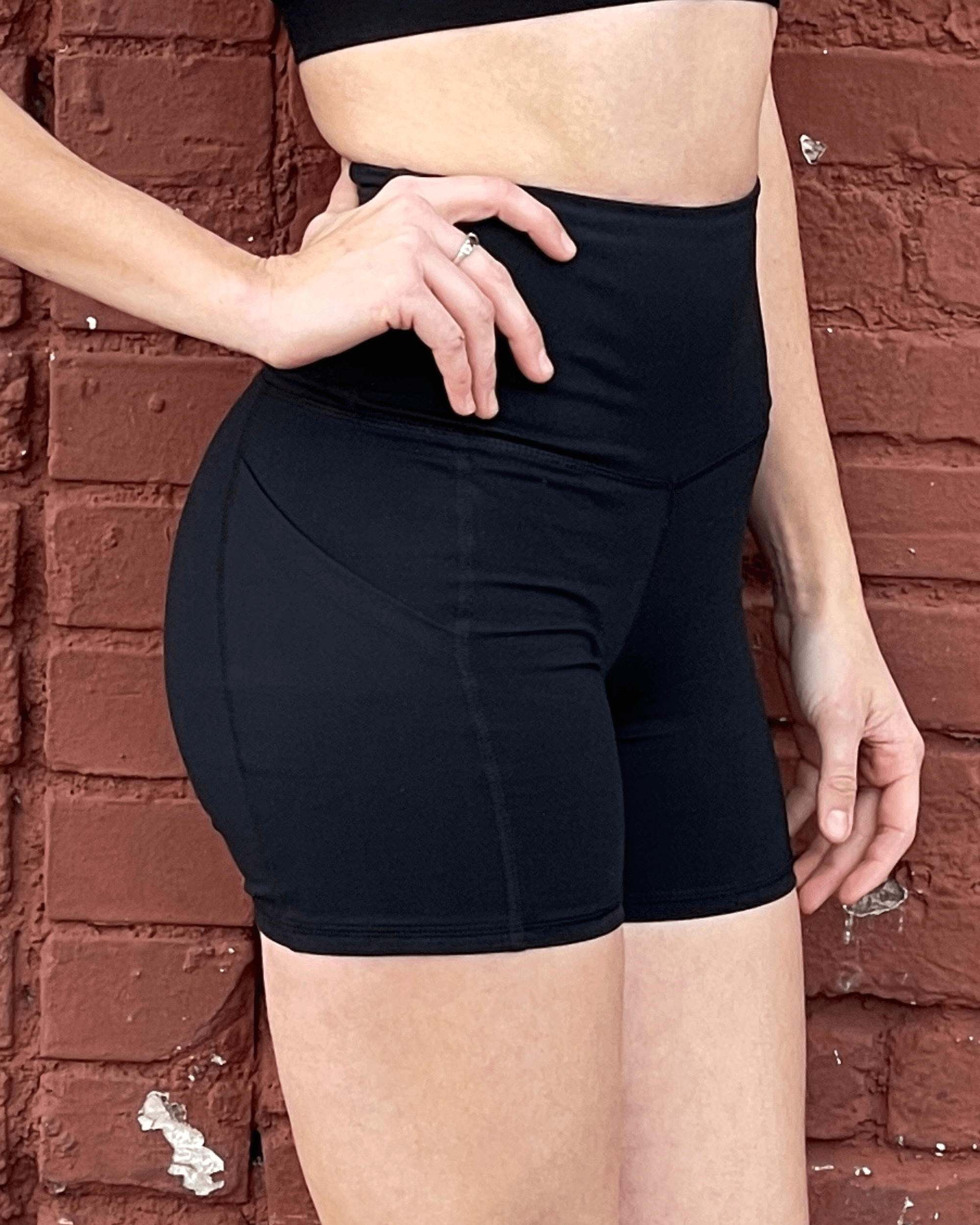 Black Lavender Jolie high-waisted athletic shorts with hip pockets, featuring a sleek black design and comfortable fit for activewear.