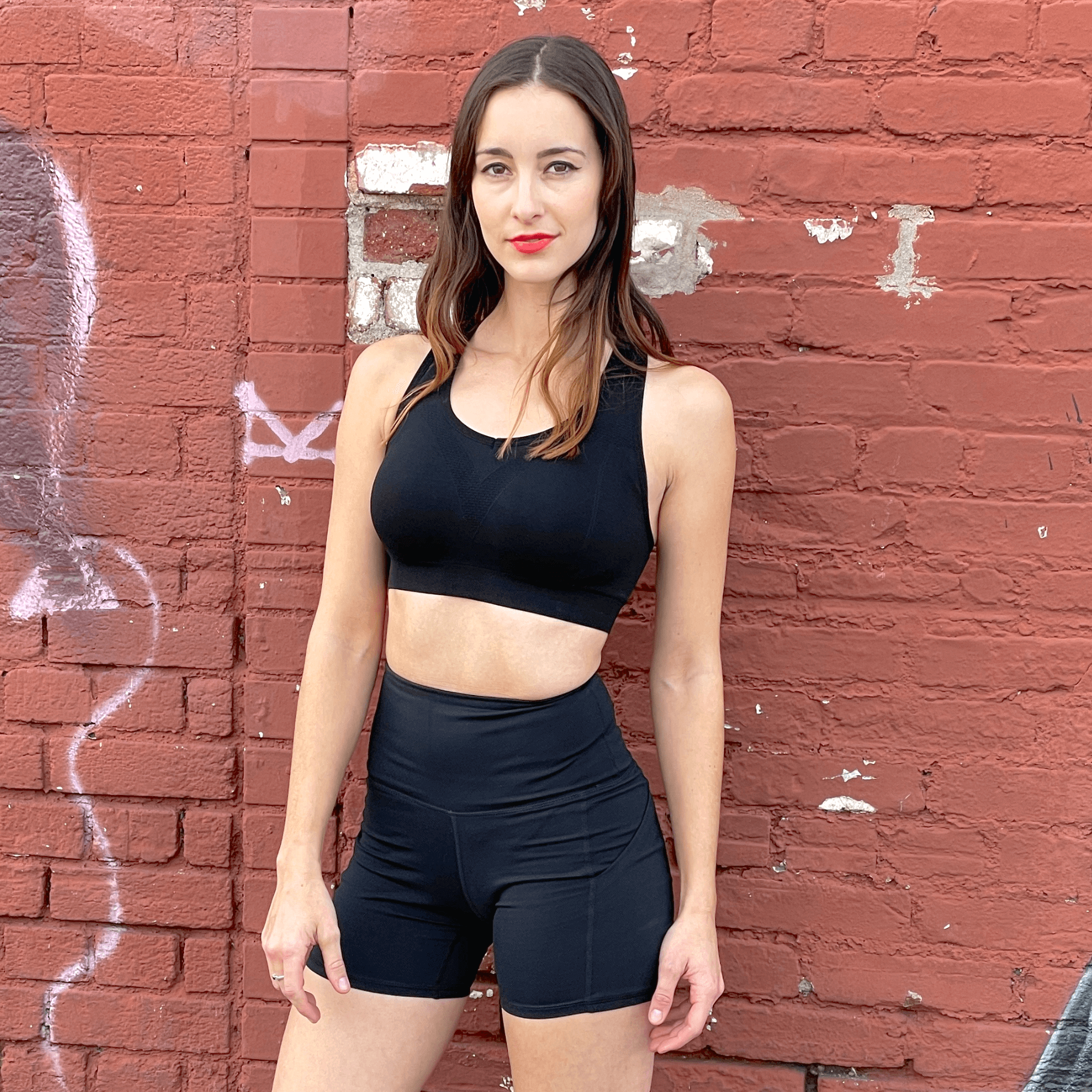 Black Lavender La Vittoria Racerback athletic sports bra shown on a hanger, highlighting its sleek design and breathable fabric.
