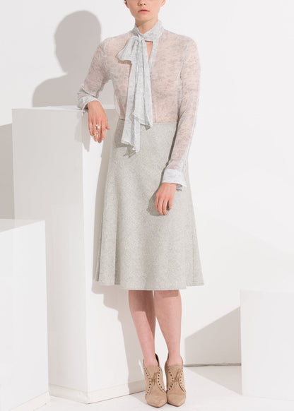 High waisted wool knit midi skirt in Heather Grey by Lemon Hera, featuring a cozy, textured fabric and a stylish, flowing silhouette.