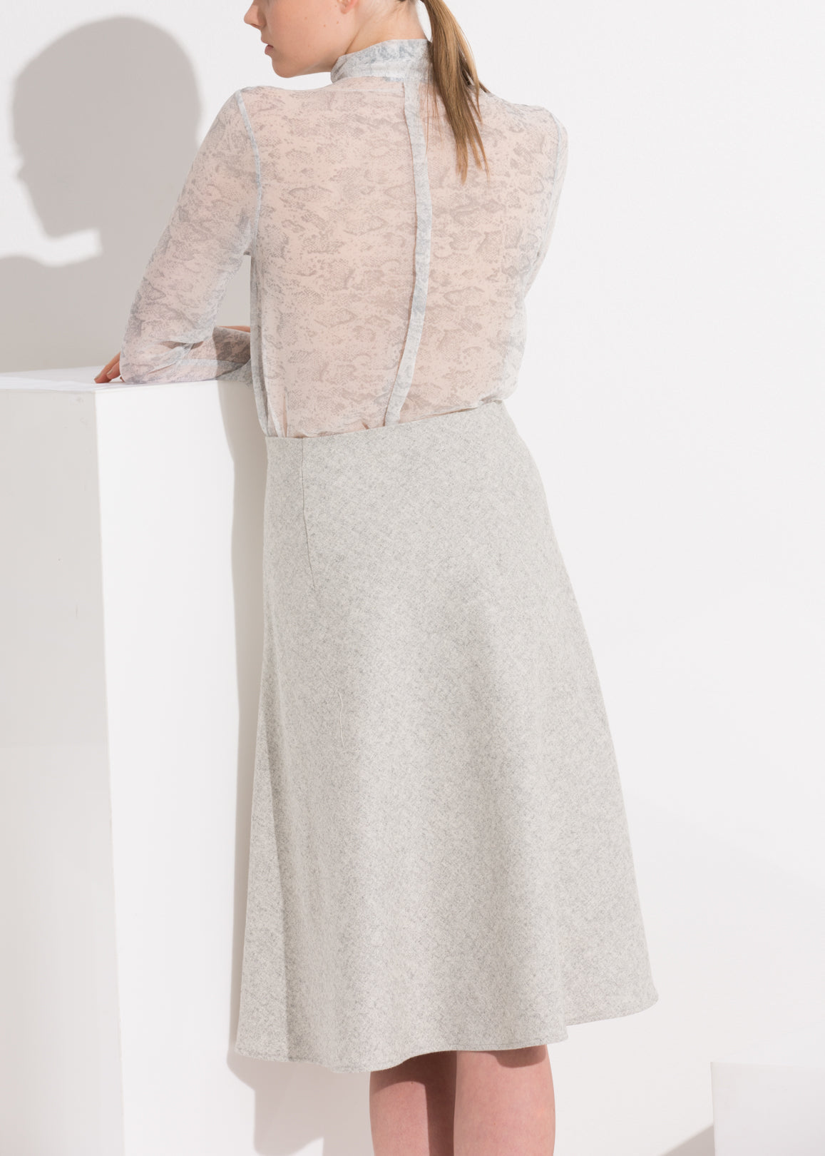 High waisted wool knit midi skirt in Heather Grey by Lemon Hera, featuring a snug fit and soft textured fabric.