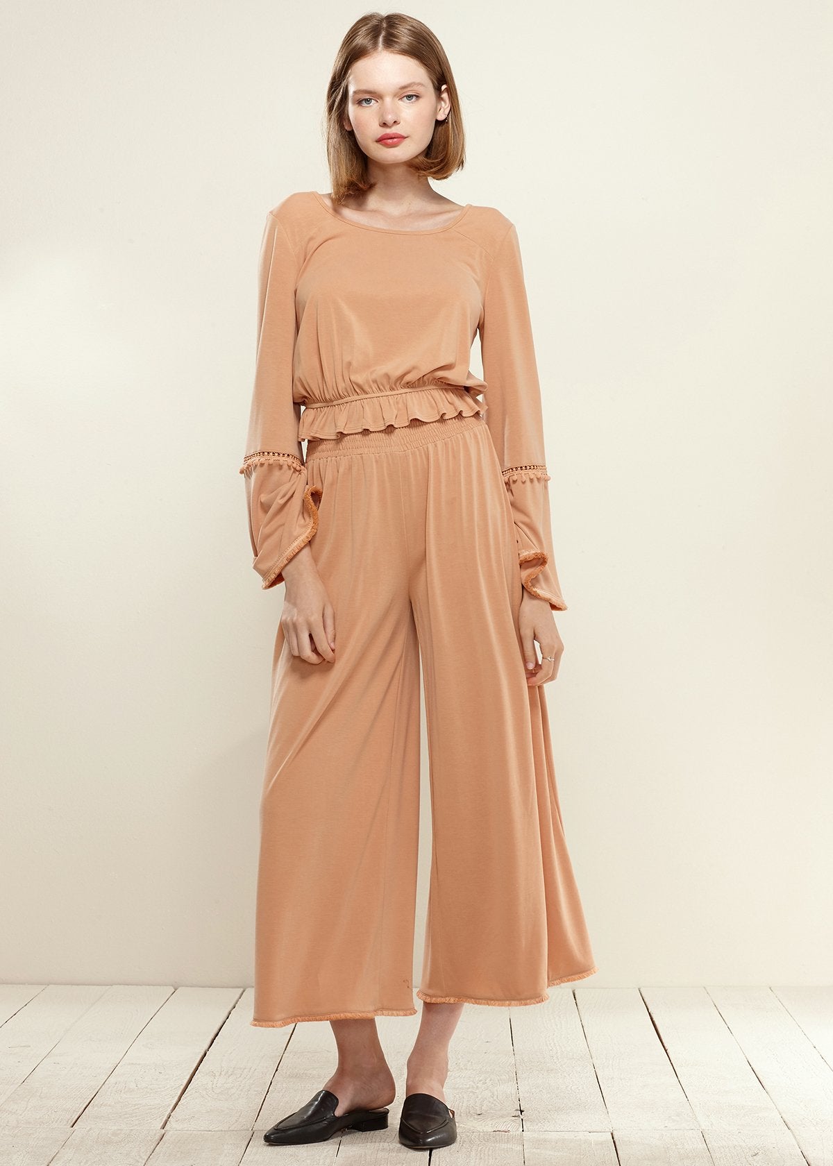 Lemon Hera smocked waist wide-leg palazzo pants in apricot fabric, featuring flowing design and relaxed fit.