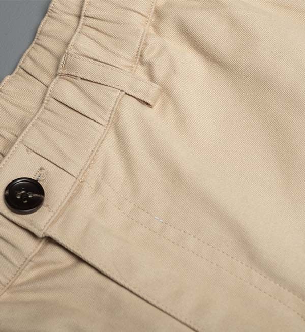 Ruby Tartarus cotton khaki swim shorts laid flat showing adjustable waistband and stitching details.