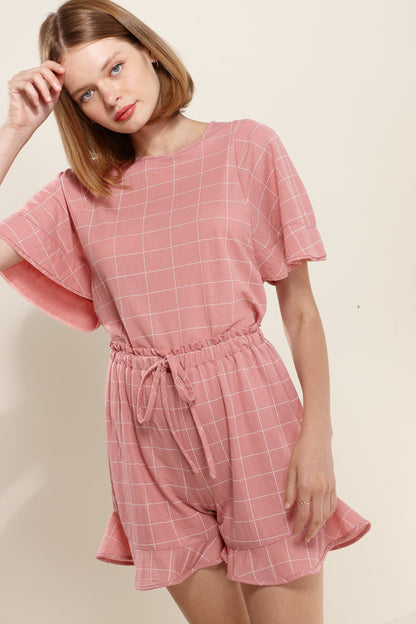 Pink high-waist shorts for women with ruffled hem by Lemon Hera, shown on a model, perfect for casual summer wear.