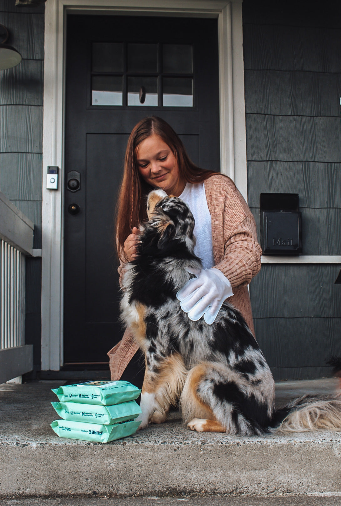 Scarlet Max Pet Glove Wipes for cleaning pets, shown being used to wipe a dog&