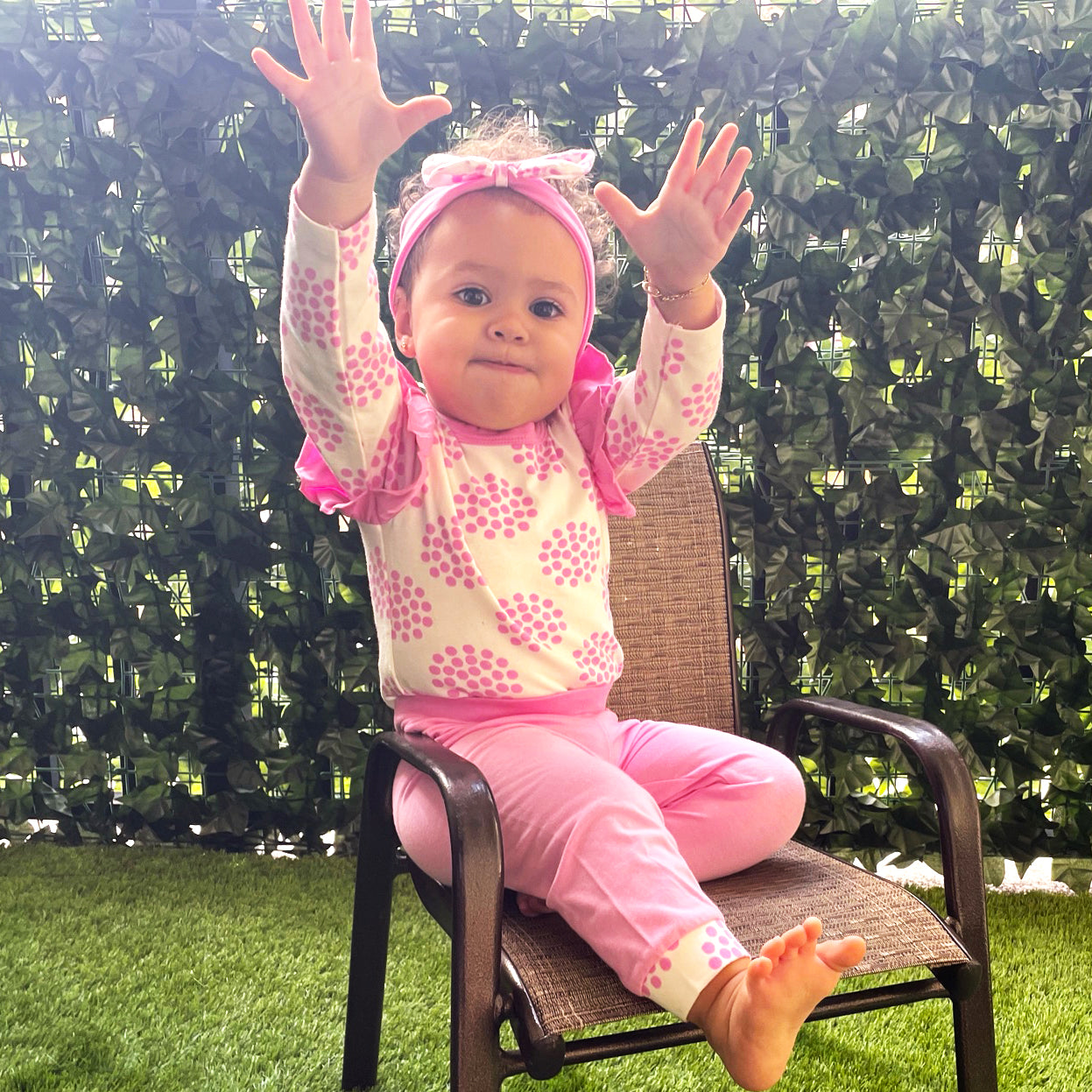 Pink polka dot baby girl layette set with onesie, pants, and headband by Black Simba, perfect for newborns and infants.