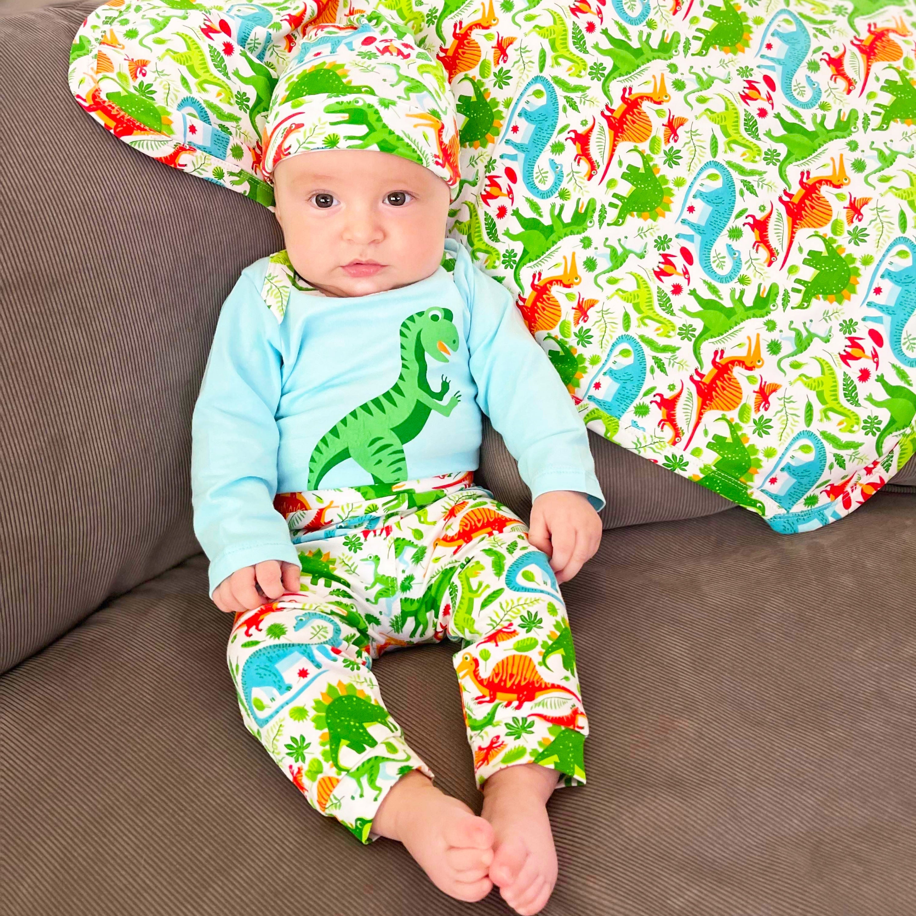 Black Simba AnnLoren baby boy dinosaur long sleeve onesie, pants, and cap set, featuring playful prehistoric dinosaur print.