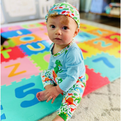 Black Simba AnnLoren baby boy dinosaur layette set with long sleeve onesie, pants, and cap featuring playful dinosaur prints.