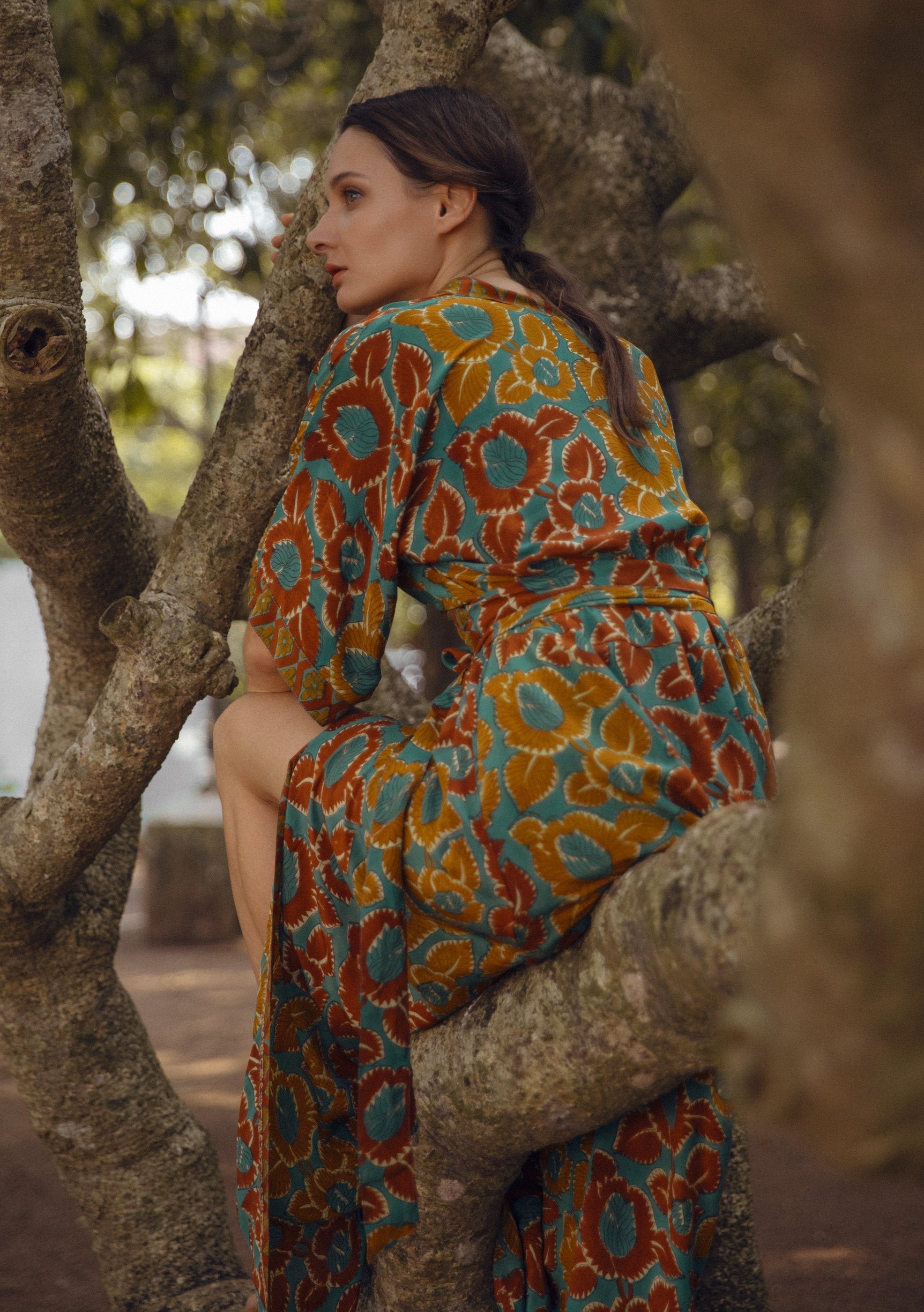 Violet Baobab Mia belted wrap dress styled with accessories, displayed in a lifestyle setting with natural light.