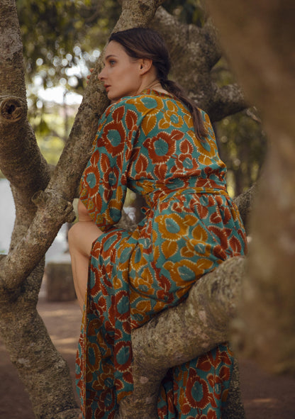 Violet Baobab Mia belted wrap dress styled with accessories, displayed in a lifestyle setting with natural light.