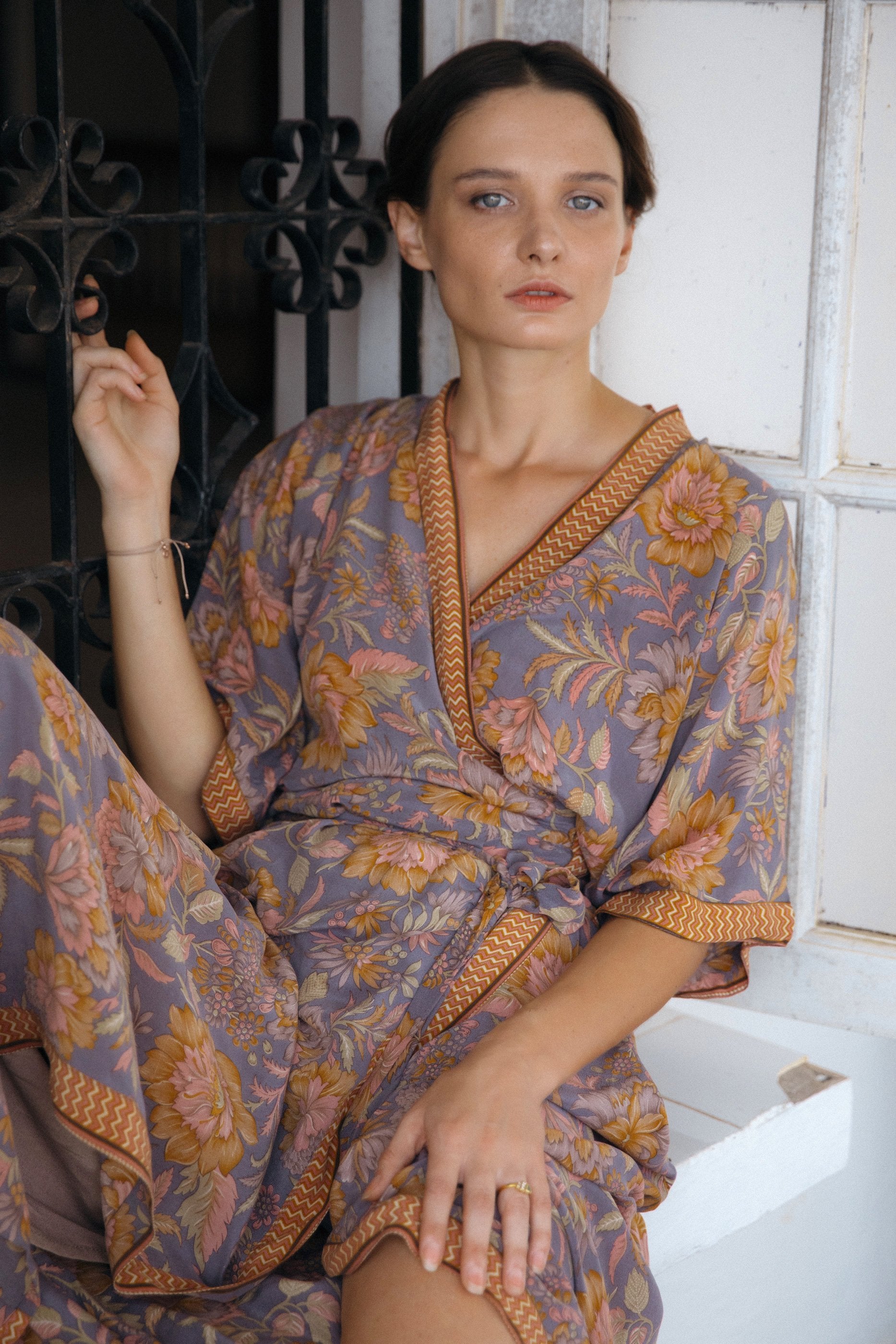 Violet Baobab Mia belted wrap dress styled as accessories, shown in a lifestyle setting with natural fabric and elegant design.