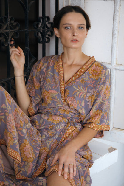 Violet Baobab Mia belted wrap dress styled as accessories, shown in a lifestyle setting with natural fabric and elegant design.