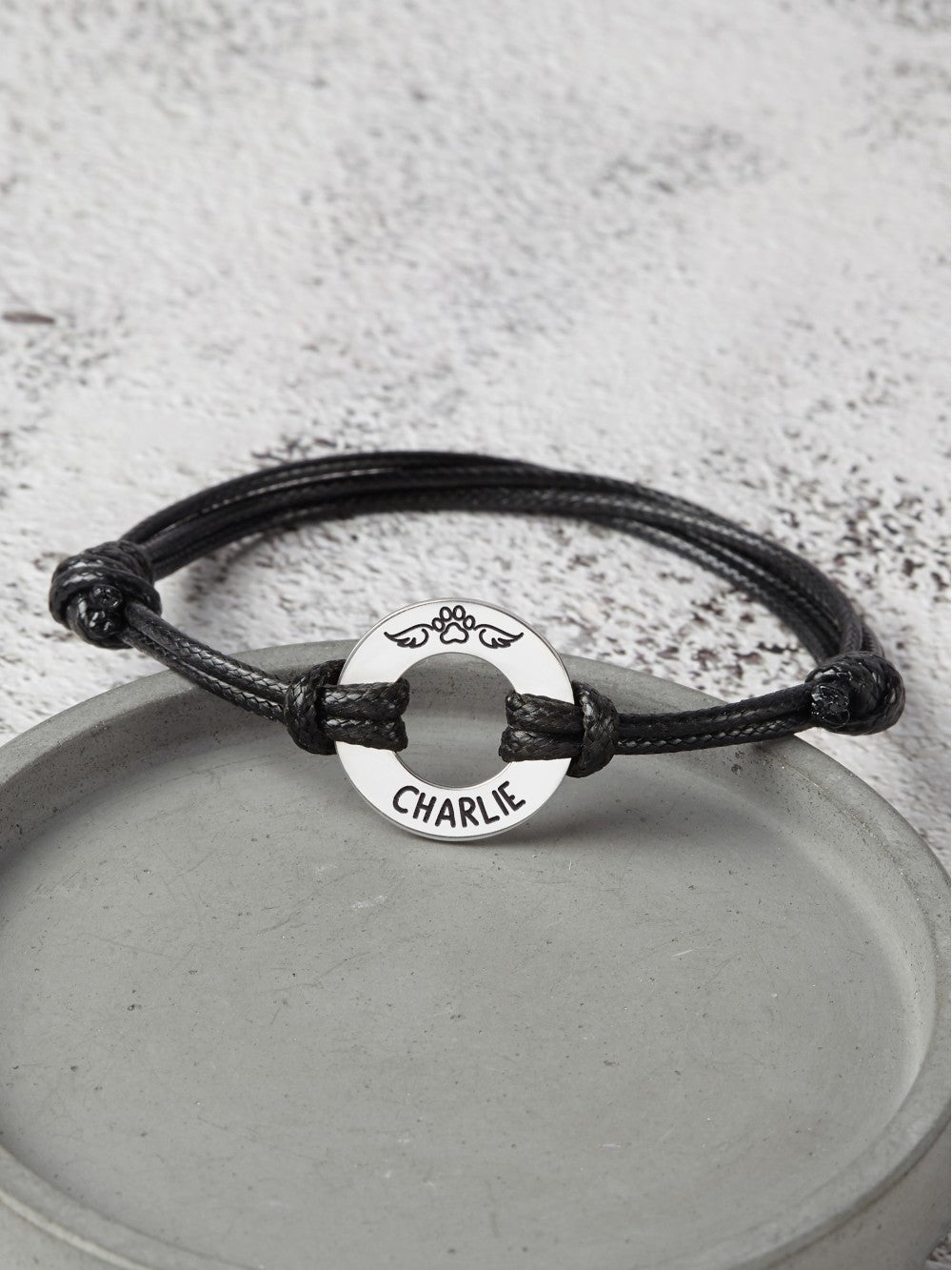 Leather bracelet with engraved pet name and dog paw charm, memorial gift for pet loss, by Green Millie.