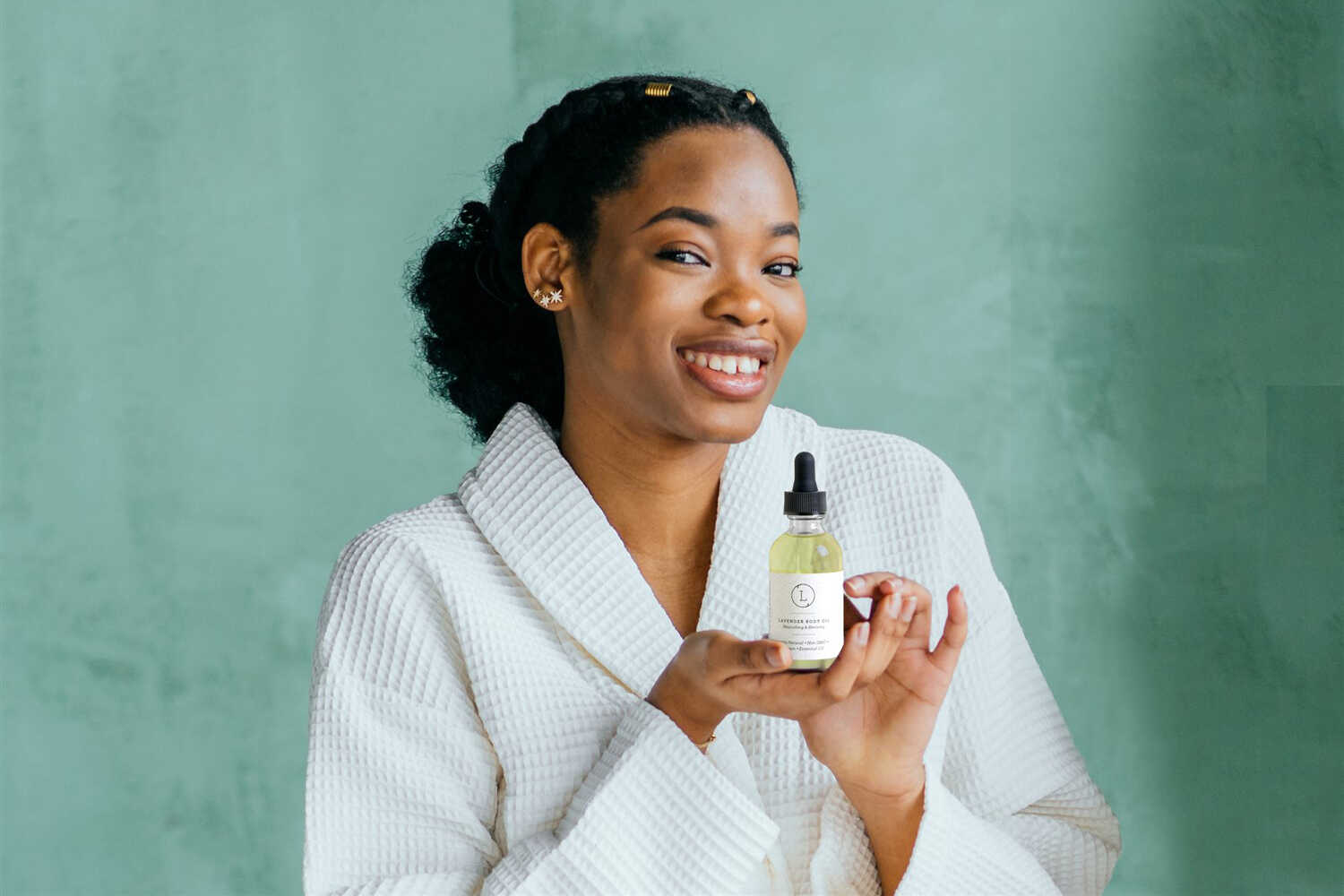 Lavender moisturizing body oil by Start2Finish, featuring a clear bottle with lavender-colored liquid and a white pump dispenser.