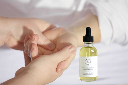 Lavender moisturizing body oil by Start2Finish featuring a clear bottle with lavender-colored oil and a pump dispenser.