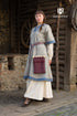 Light grey and light blue Rus Dress Luiza by Azure Briseis, perfect for festivals and parties, shown on a model against a vibrant background.