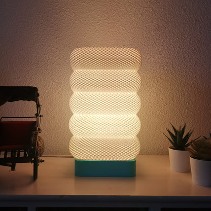 Azure Pontus LumaCell table lamp with modern design and warm lighting, featuring a sleek base and adjustable shade.
