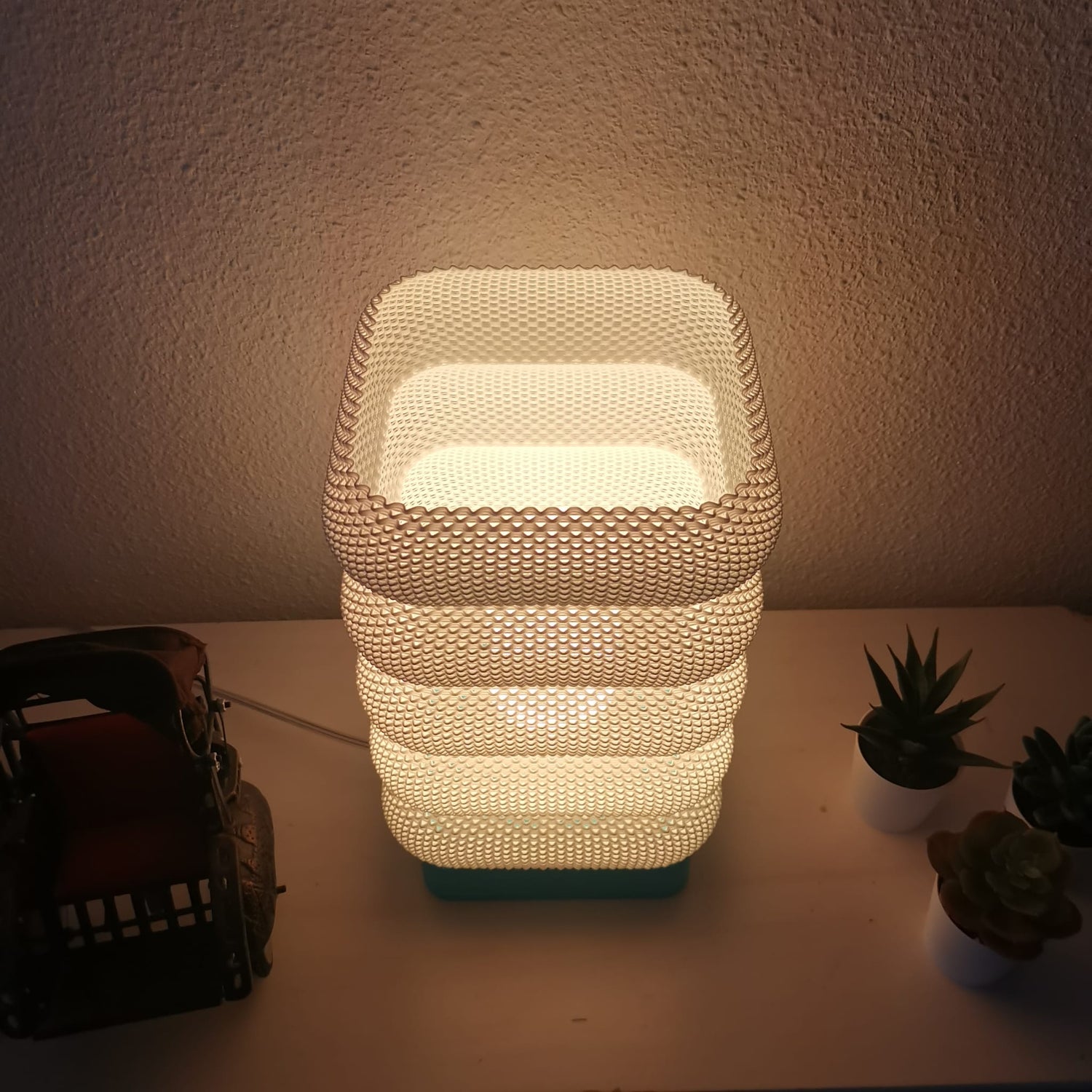 Azure Pontus LumaCell table lamp with sleek modern design and soft illuminated glass shade for ambient lighting.