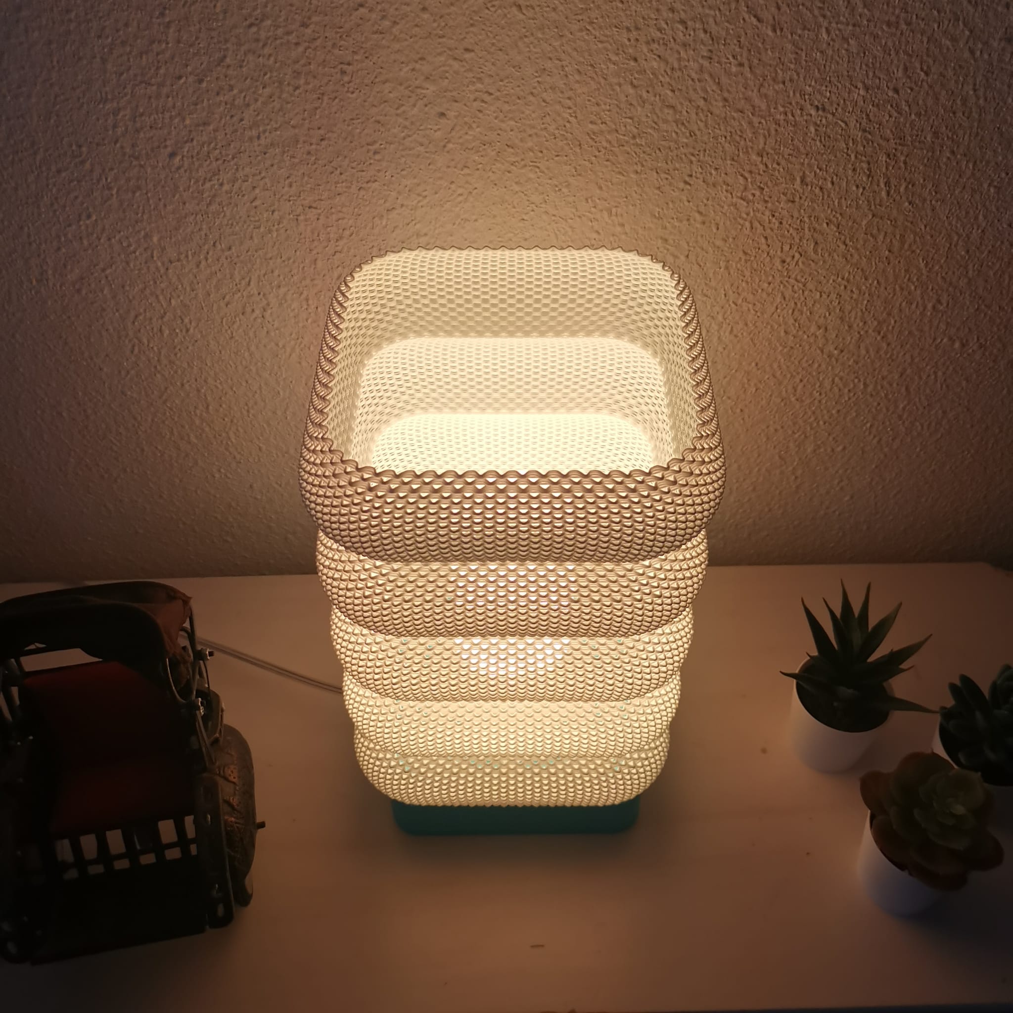 Azure Pontus LumaCell table lamp with sleek modern design and soft illuminated glass shade for ambient lighting.