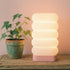 Azure Pontus LumaCell table lamp with modern design, featuring a sleek base and a glowing cylindrical light for stylish lighting.