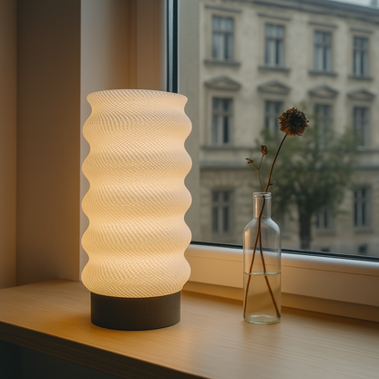 Azure Pontus Lumina Twist table lamp with sleek, modern design featuring a twisting metal base and a cylindrical lampshade.