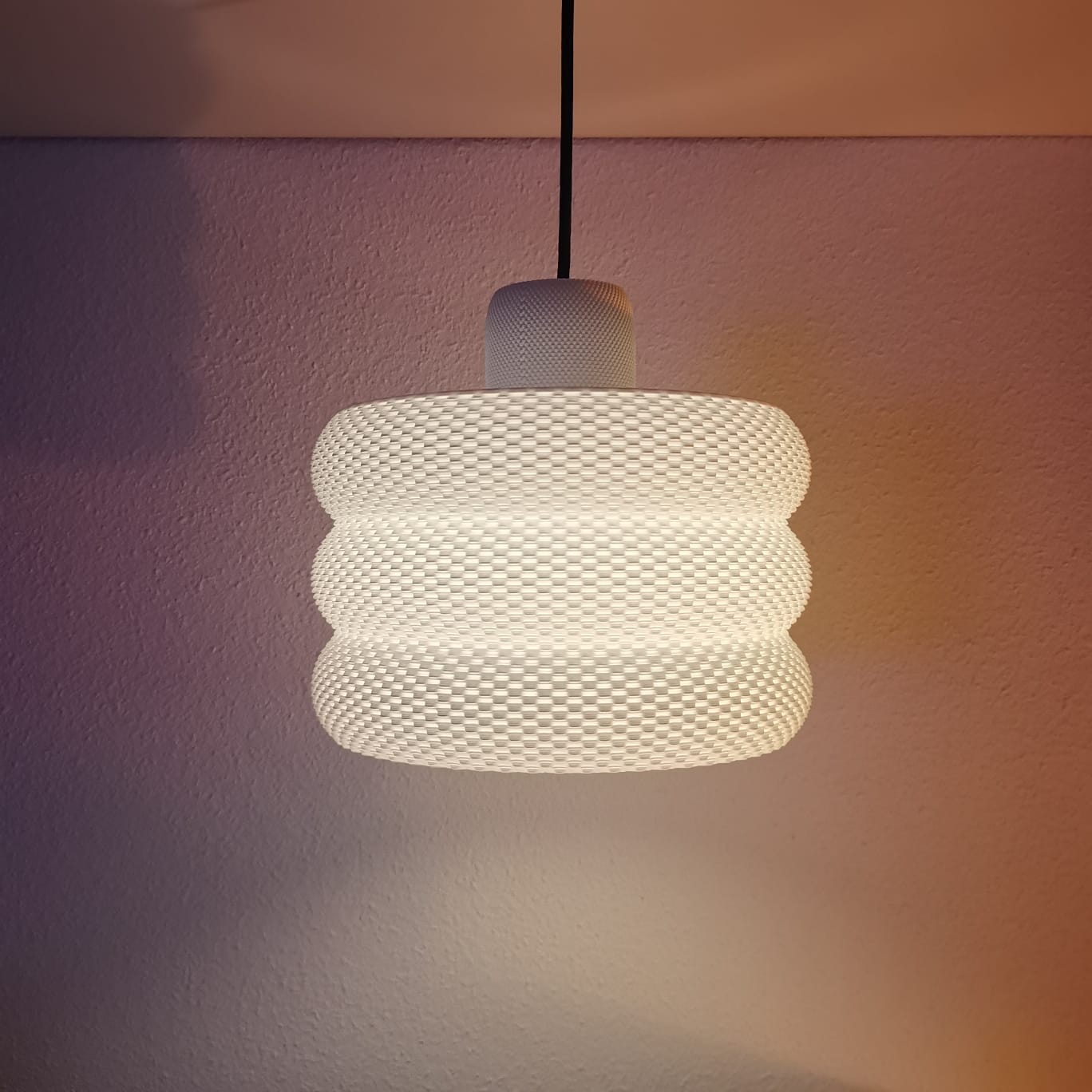 Azure Pontus Luminous Hive Pendant Lamp hanging with a warm glow, showcasing a modern geometric lighting fixture.