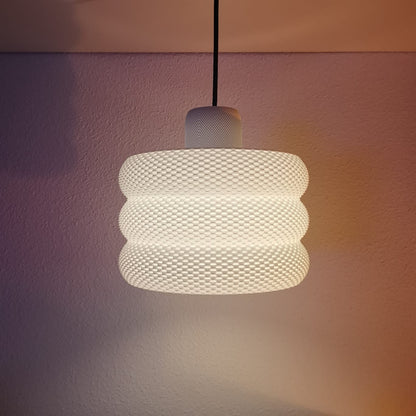 Azure Pontus Luminous Hive Pendant Lamp hanging with a warm glow, showcasing a modern geometric lighting fixture.