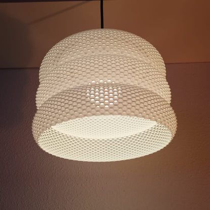 Azure Pontus Luminous Hive Pendant Lamp hanging from ceiling, showcasing its intricate, glowing geometric design in a modern lighting setup.