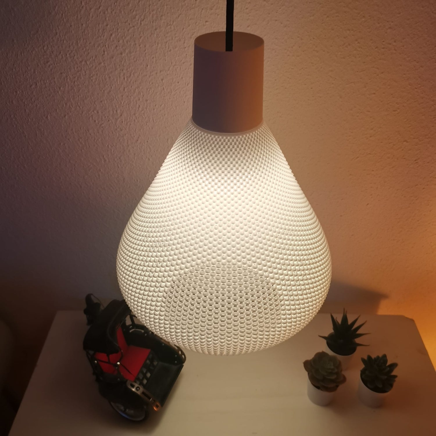Azure Pontus Lumisera pendant lamp hanging with a sleek, modern design and a warm glow, ideal for contemporary interior lighting.