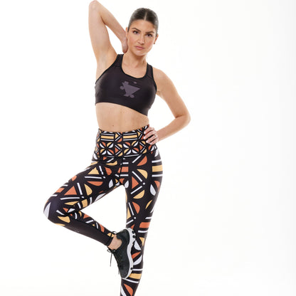 White Oliver Batiq Vibrant Leggings in colorful activewear with a high-waist design, shown on a model in a fitness setting.