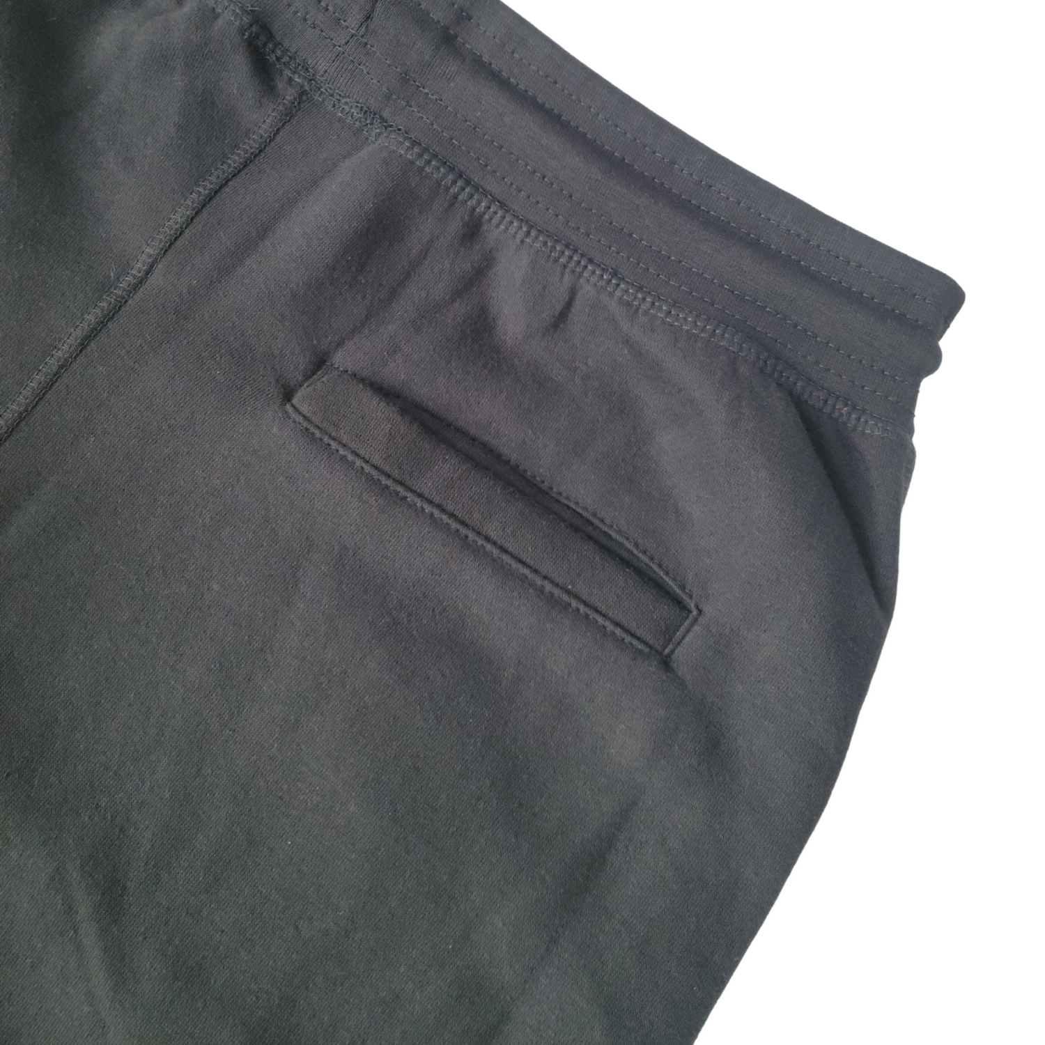 Gray Makade Black Joggers from Grey Trillium, casual sweatpants with elastic waistband and tapered fit, laid flat.