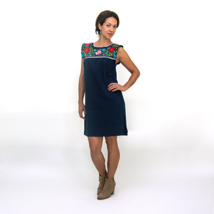 White hand-embroidered Mexican loose dress for women by Violet Athena, showcasing intricate embroidery and relaxed fit.