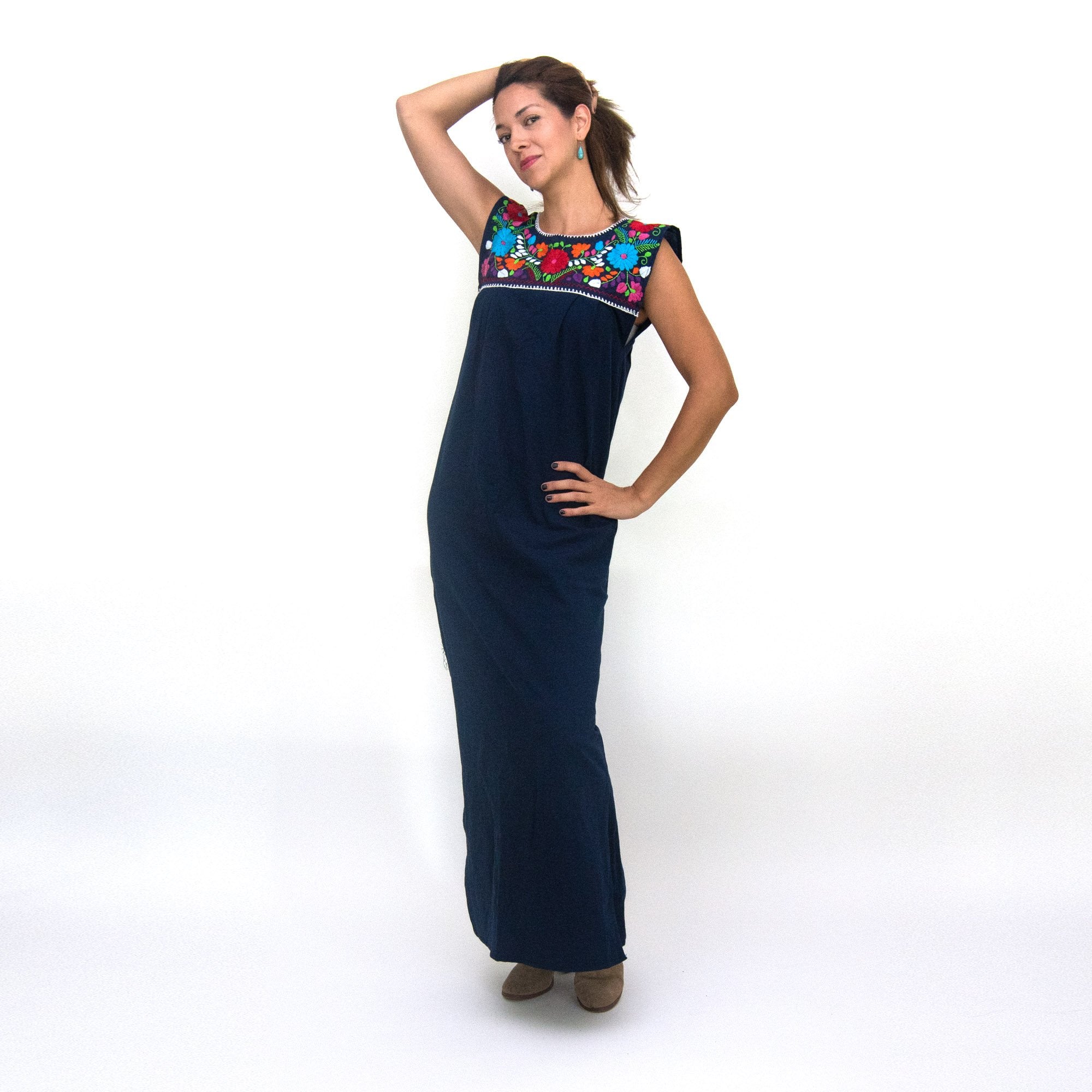Hand-embroidered Maxi Isidra Mexican loose dress for women by Violet Athena, featuring intricate white embroidery and flowing fabric.