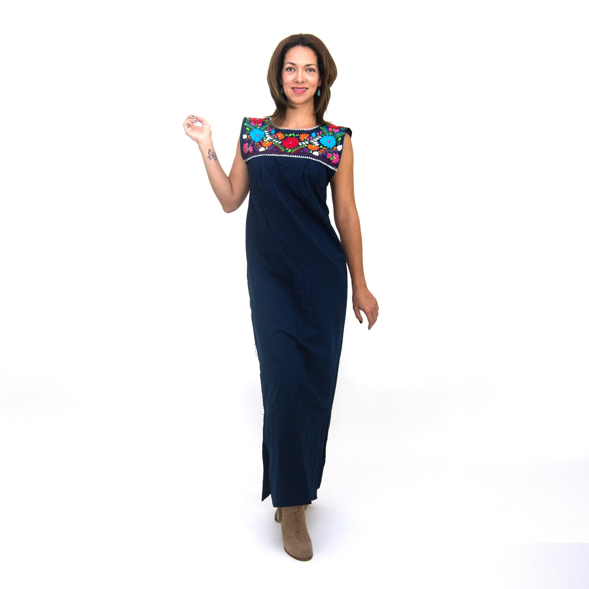Hand-embroidered white Maxi Isidra Mexican loose dress for women by Violet Athena, featuring intricate embroidery and flowing fabric.