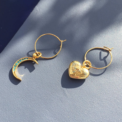 Yellow Athena crystal moon earrings featuring crescent moon and heart-shaped accents, elegant jewelry for stylish occasions.