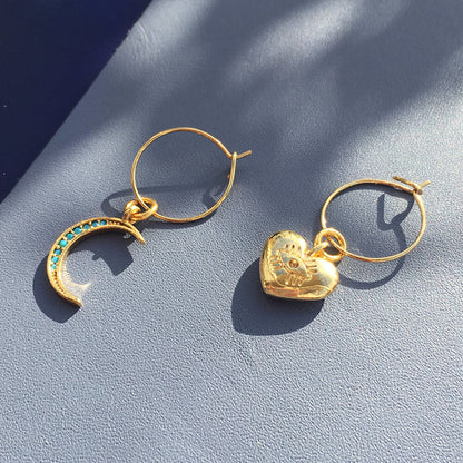 Yellow Athena crystal moon earrings featuring crescent moon and heart-shaped accents, elegant jewelry for stylish occasions.