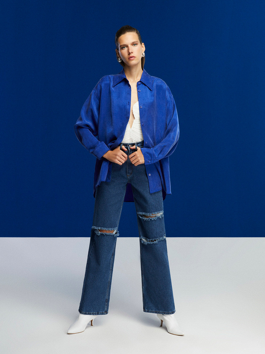 Bronze Aphrodite high-waisted ripped jeans for women, showcasing distressed denim with a fitted waist and stylish ripped details.