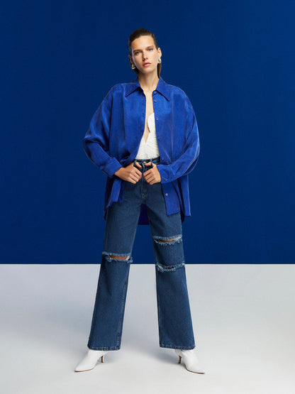 Bronze Aphrodite high-waisted ripped jeans for women, showcasing distressed denim with a fitted waist and stylish ripped details.