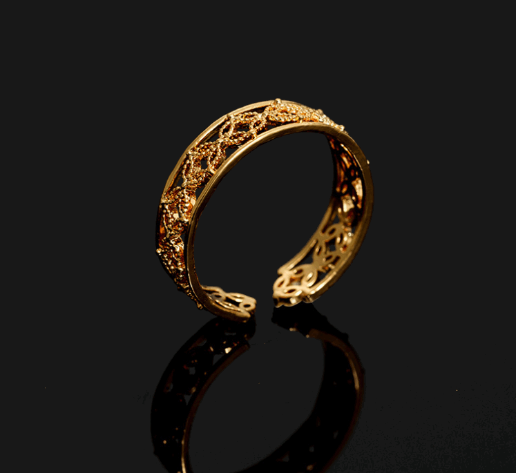 Gold Hélodie ring by Lime Cress featuring intricate floral design, set on a neutral background.