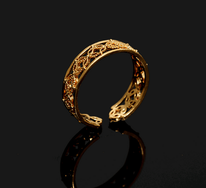 Gold Hélodie ring by Lime Cress featuring intricate floral design, set on a neutral background.