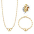 Lavender Phoebe paperclip link jewelry set featuring layered gold-tone necklaces and matching earrings on a white background.